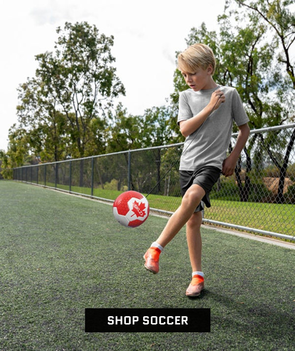 Athlete Kicking red and white soccer ball. Shop Soccer