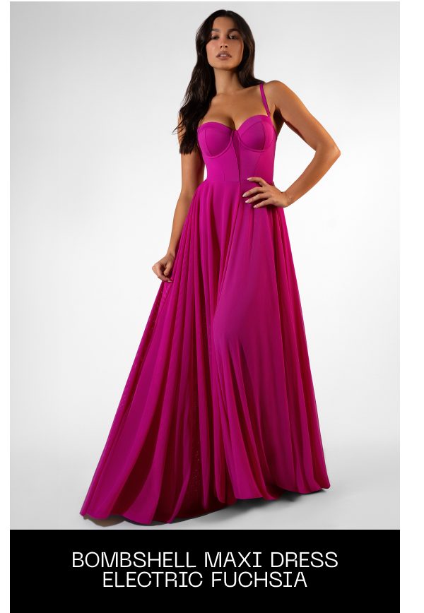 A model wearing a long, electric fuchsia maxi dress with a fitted bodice and flowing skirt.