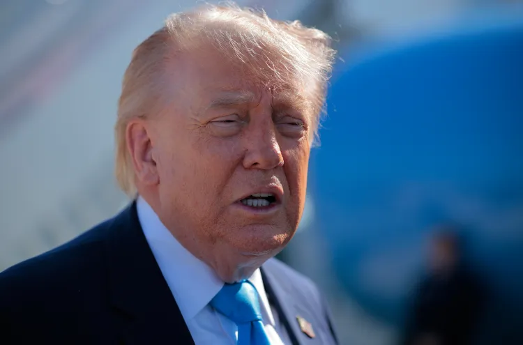 Donald Trump in a navy suit with white shirt and a light blue tie.