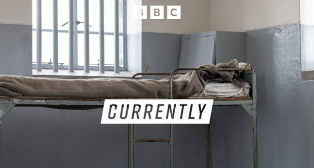 The inside of a prison cell with a metal bunk bed next to a barred window. The word 'currently' is overlaid across the lower centre of the image, while the BBC logo is at the top.