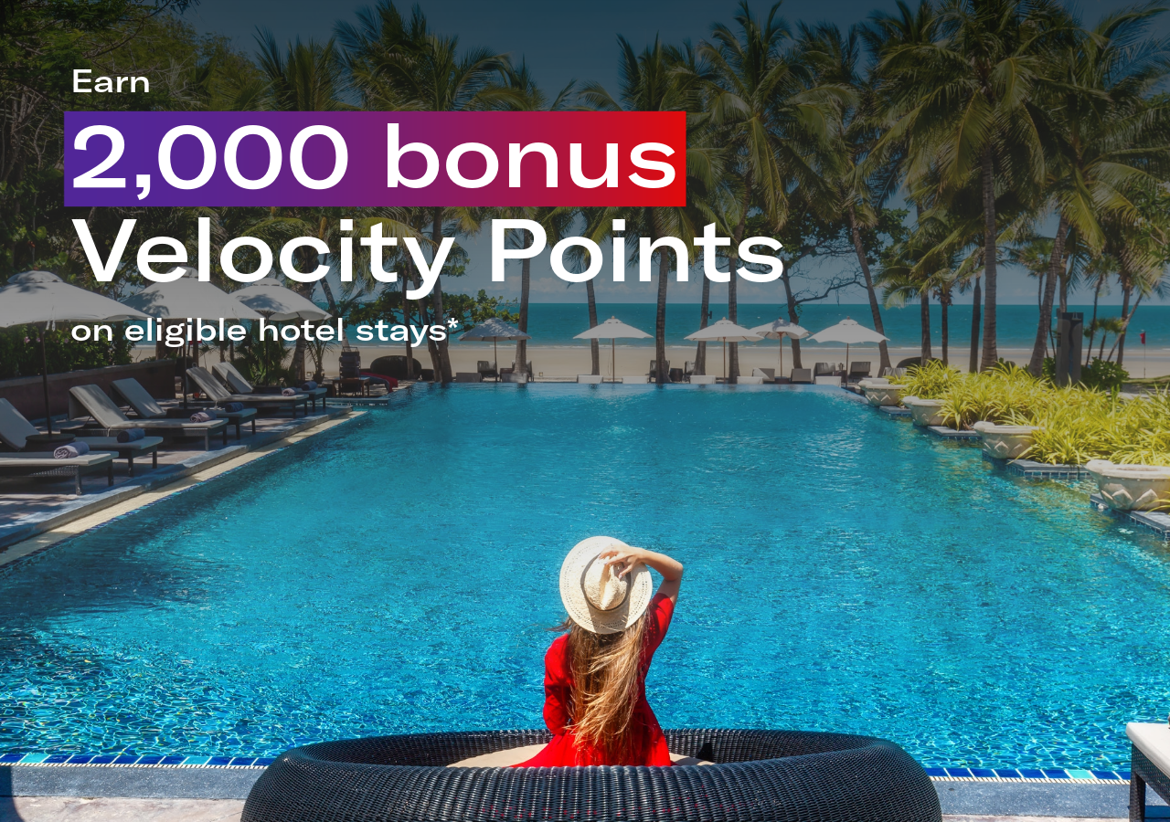 Image of a woman by a pool with text: Earn 2,000 bonus Velocity Points on eligible hotel stays*
