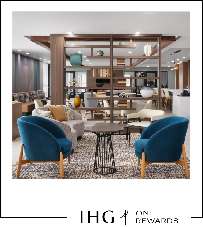 A hotel lounge area with a bar, many sitting areas, and a focal bookshelf as an accent piece in the room.
