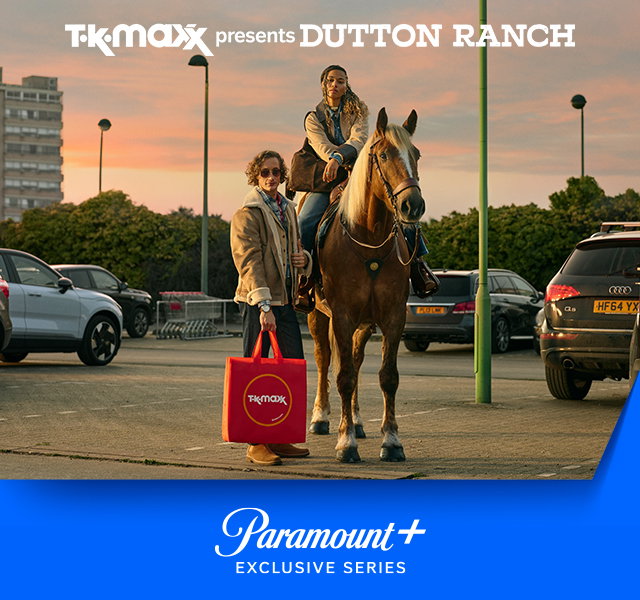 A woman riding a horse in a carpark, stood next to a man with a TK Maxx red tote bag.