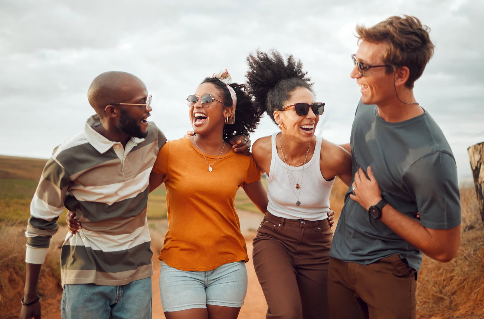 2 men and 2 women outside smiling and laughing together