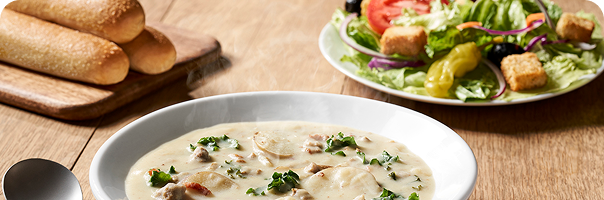 Image of Olive Garden’s signature soup, salad, and breadsticks.