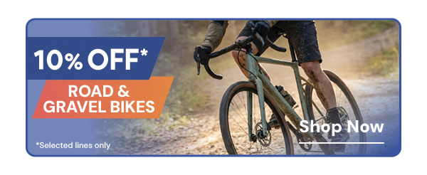 10% OFF ROAD & GRAVEL BIKES* *Selected Lines Only. A man cycles along a gravel path on a Specialized Turbo Creo 2 Comp Gravel E-Bike in Green.