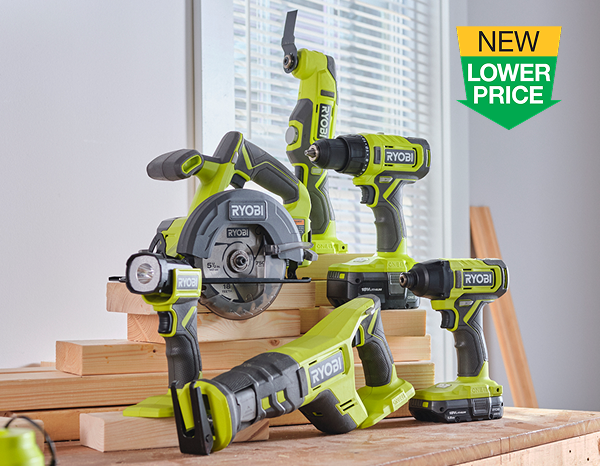 Six RYOBI 18V ONE+ cordless tools arranged on a wooden workbench, including a circular saw, drill, reciprocating saw, and multi-tool, with a "New Lower Price" badge