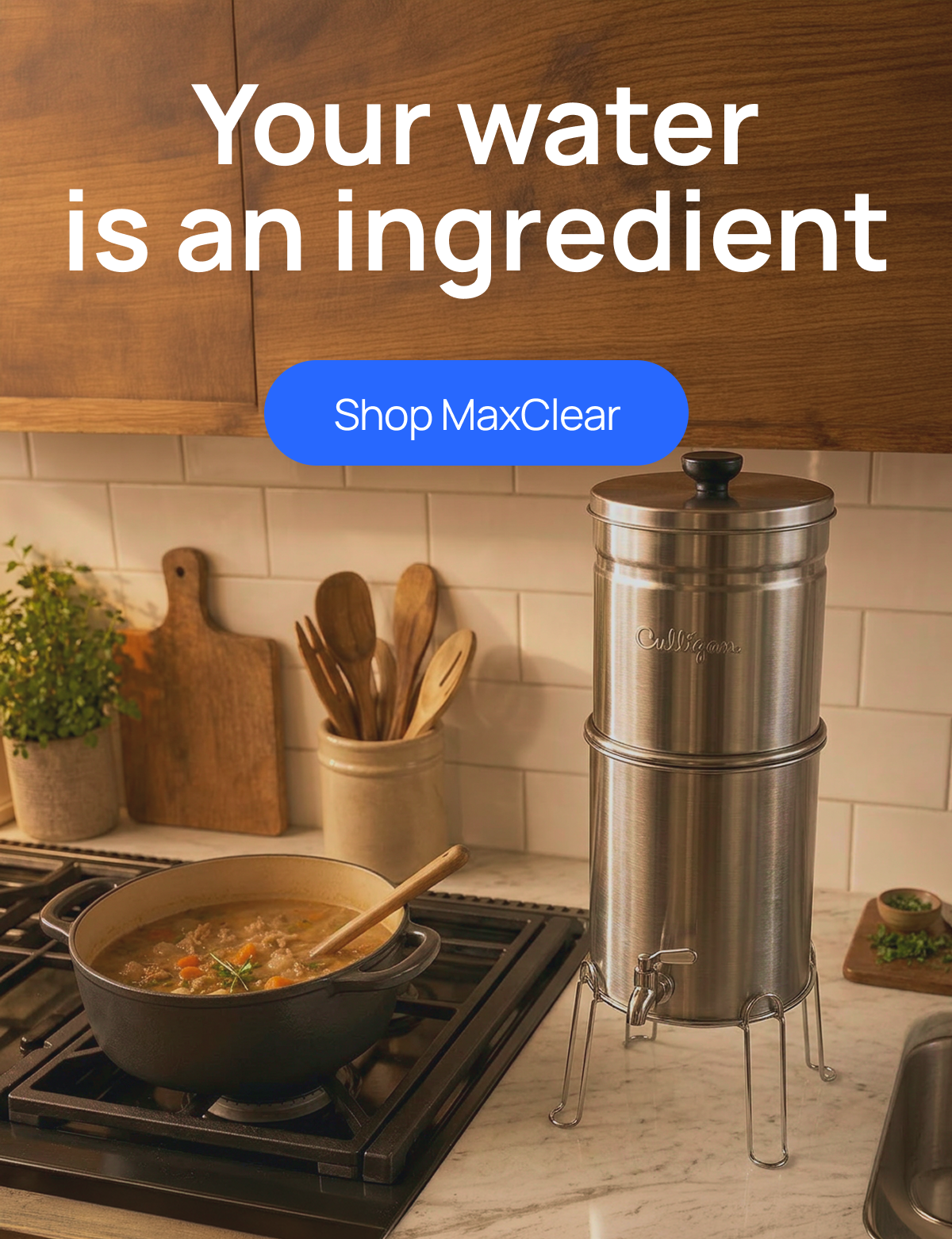 Culligan gravity filter in a home kitchen with a pot of soup cooking next to it.