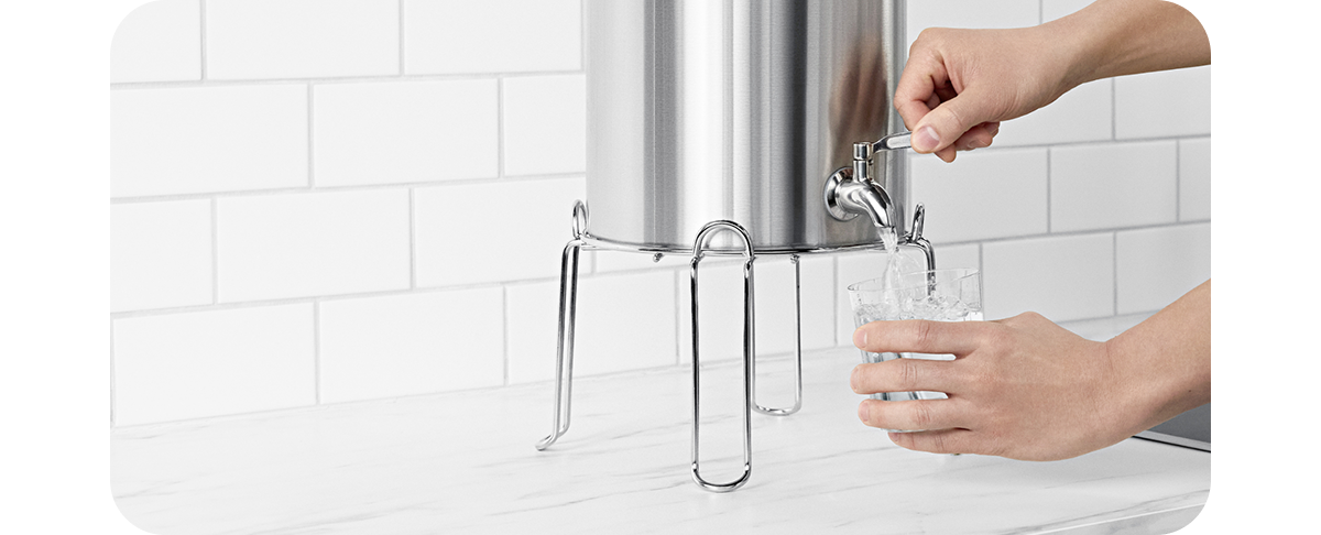 Gravity filter, pouring filtered water into a glass.