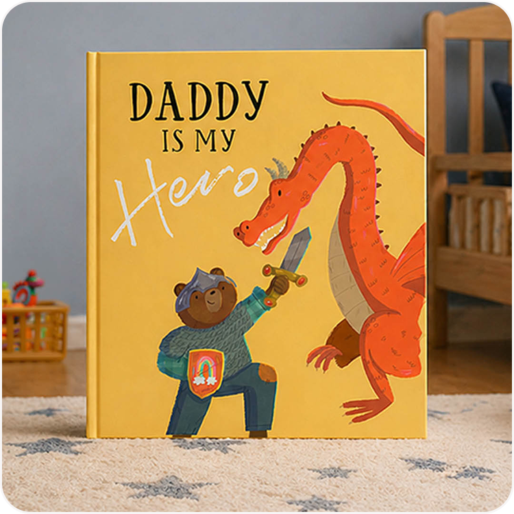 A personalised "Daddy Is My Hero" book with a illustrated dragon and bear cub on the cover, displayed in a child's bedroom