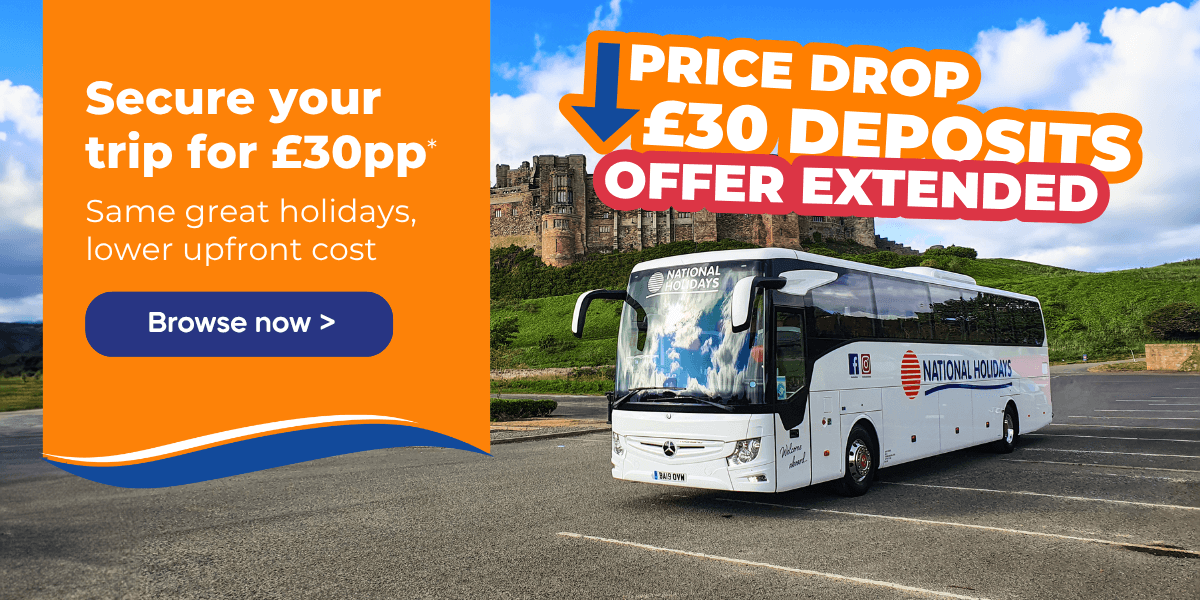 A coach parked in a scenic area with a castle in the background and promotional text overlay.