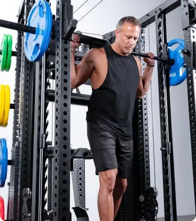 Man in his 50s working out on Force USA C20 All-In-One trainer