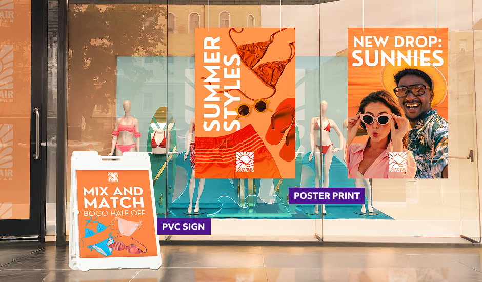 A retail storefront window features large, colorful summer graphics, including a poster with swimsuits and sunglasses, and a sidewalk sign promoting a ”Mix and Match” BOGO promotion.