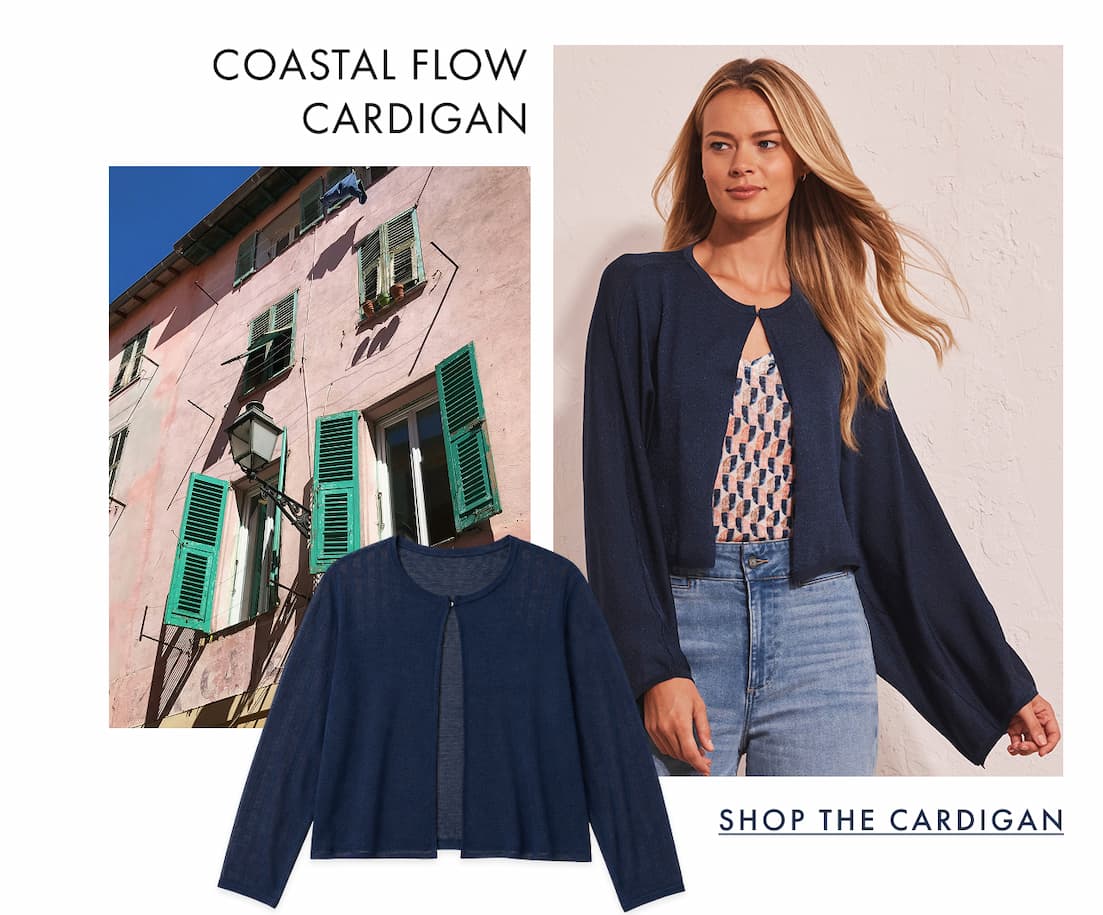 The lady wearing the Coastal Flow Cardigan. The image showcases a vibrant pink wall featuring a contrasting green window.