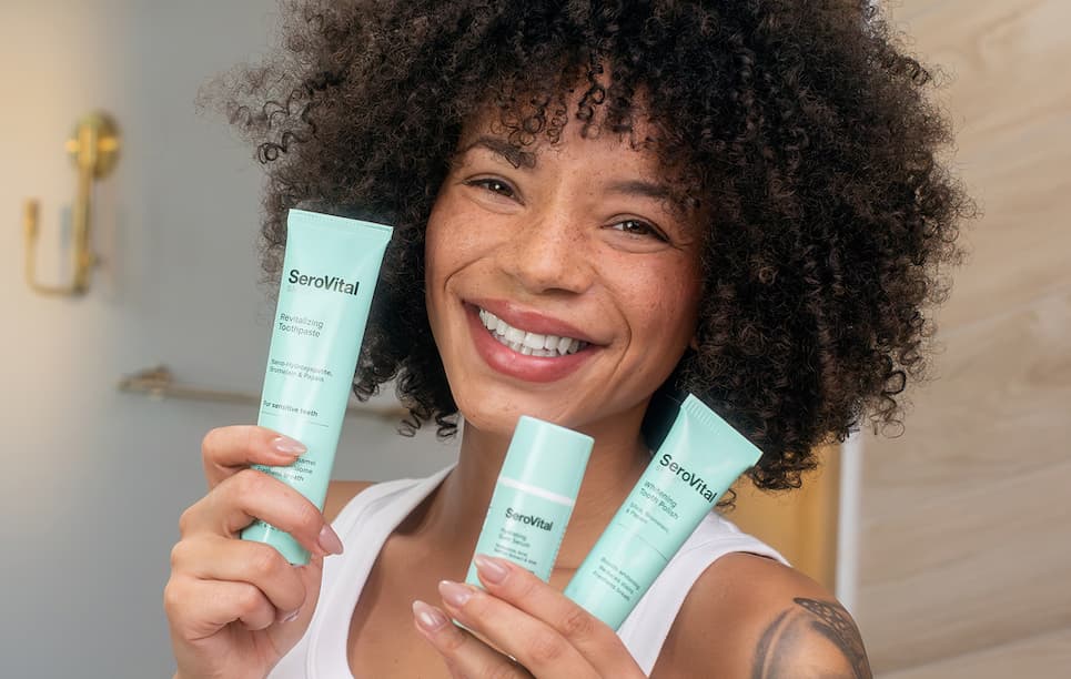 Model holding products from Smile Care line. 