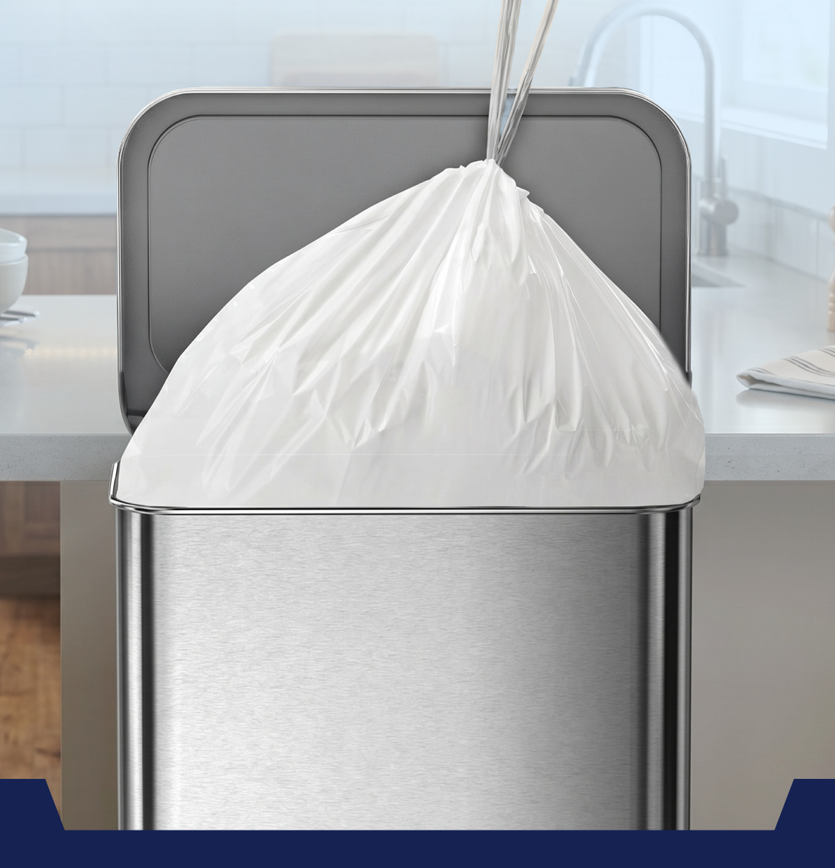 A stainless steel trash can with a white garbage bag on top.