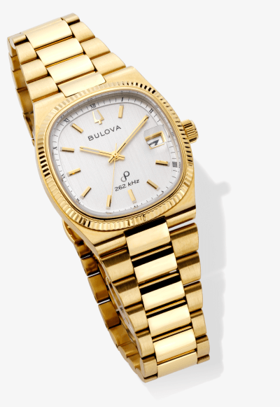 Yellow gold Bulova watch with silver dial, fluted bezel, and date display bracelet design.