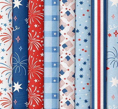Quilting fabrics with patriotic prints in reds, whites, and blues. >>