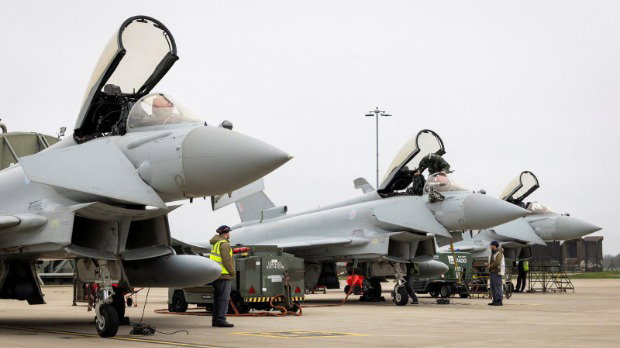Three RAF Typhoon aircraft, with their canopies open, prepare to depart RAF Coningsby for Qatar.