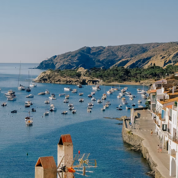 Boats moored in the harbour at Cadaqués, linking to BA High Life site.