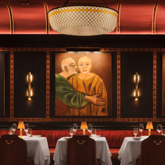 Tables laid in the intimate interior of Carbone, linking to BA High Life site.