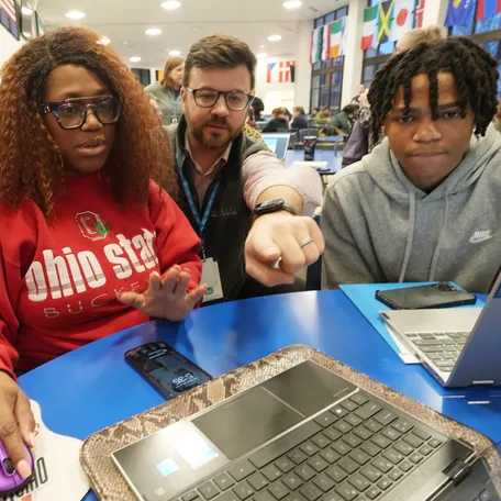 In Grove City, Ohio, Tomica Livingston and her son get assistance filling out the FAFSA from college advisers during an event in January 2024 at Central Crossing High School.
