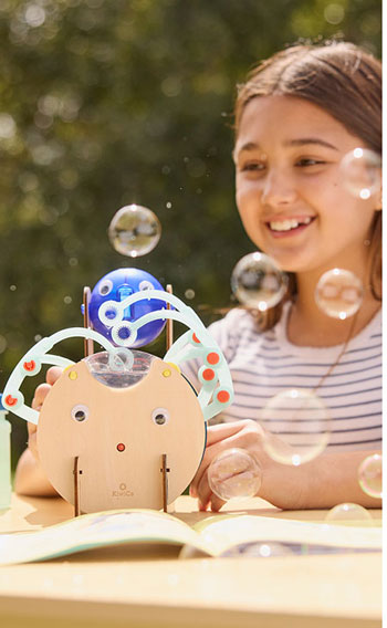 Automatic Bubble Blower from Tinker Crate. A young girl playing with a bubble-making machine.