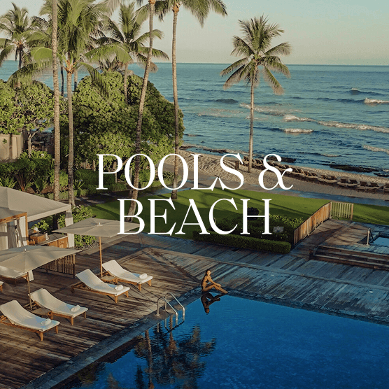 Woman sitting at the edge of a pool with the ocean beyond. Text overlay: Pools & Beach.