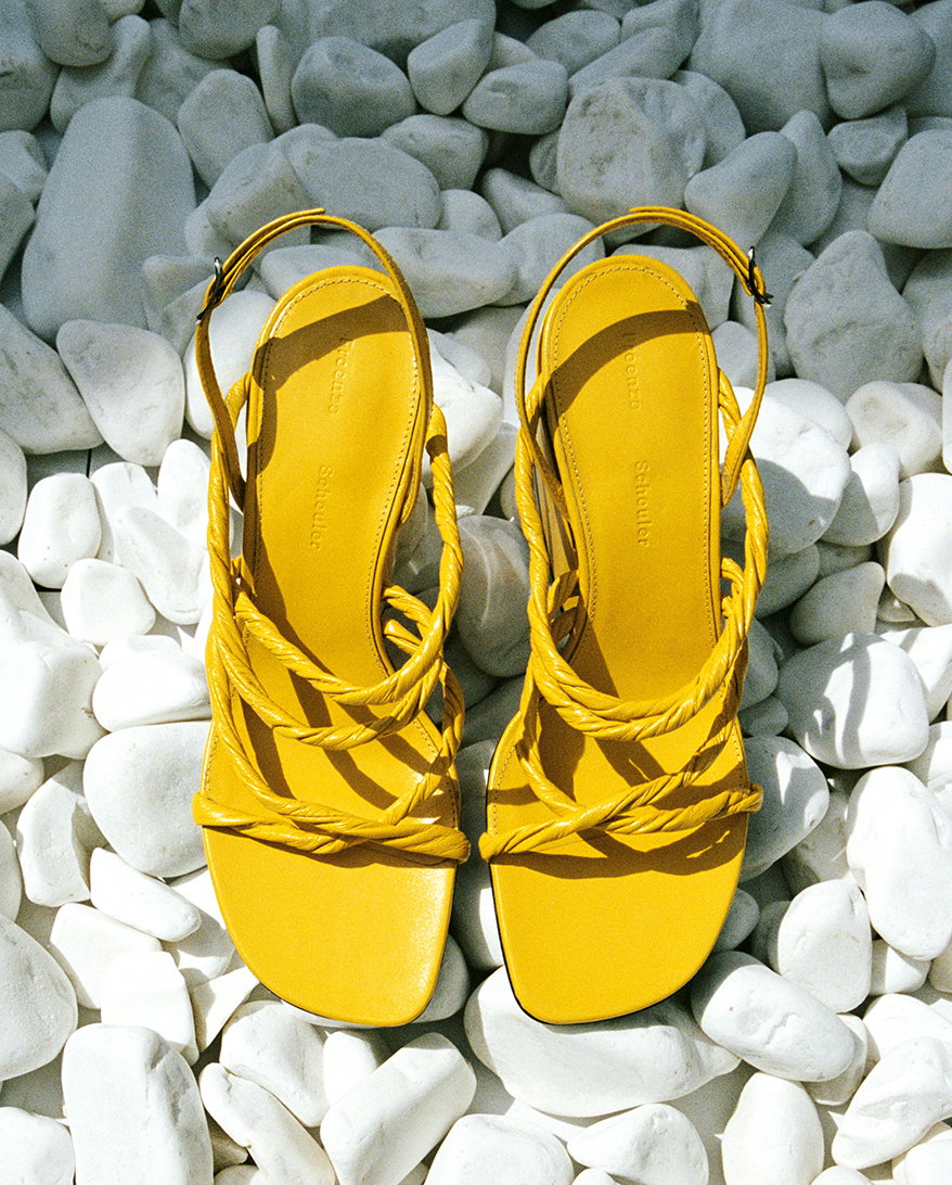 Still Life image of Twist Slant Sandals in Sun set on a bed of white rocks