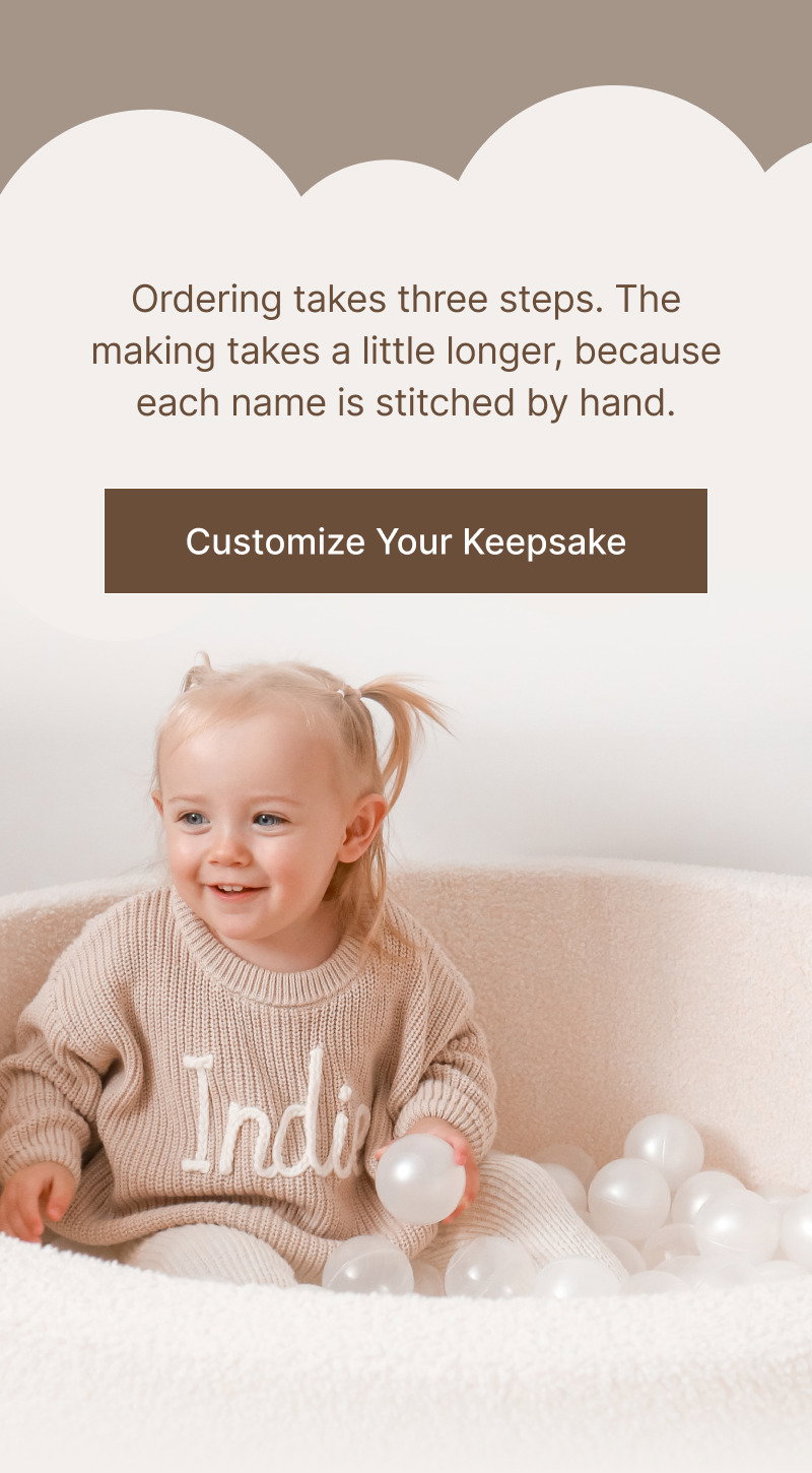 Brown text explaining production timing above a brown button reading Customize Your Keepsake, followed by an image of a smiling child wearing a personalized knit sweater while sitting among soft play balls.