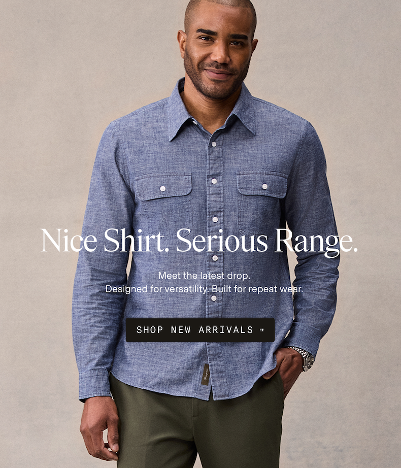 Man wearing a blue chambray button-up work shirt with dual chest pockets and olive trousers. Nice Shirt. Serious Range. Meet the latest drop. Designed for versatility. Built for repeat wear. SHOP NEW ARRIVALS →