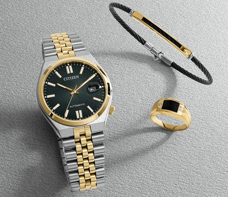 Silver and gold Citizen watch, black braided bracelet with gold accents, and black and gold signet ring.