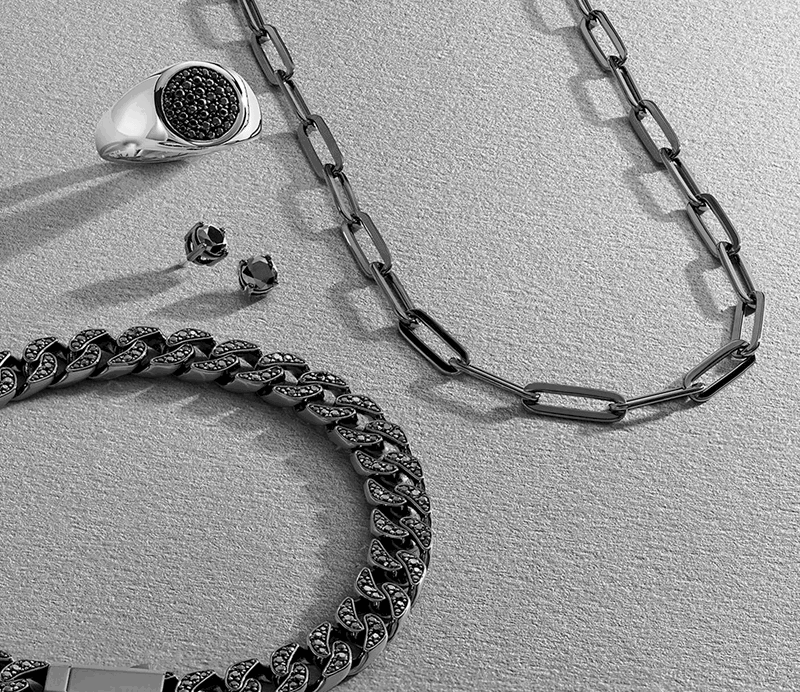 Black metal and diamond chain, silver and black diamond signet ring, black diamond studs, black metal chain.