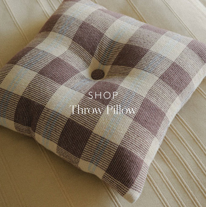 Detail of a square brown check throw pillow