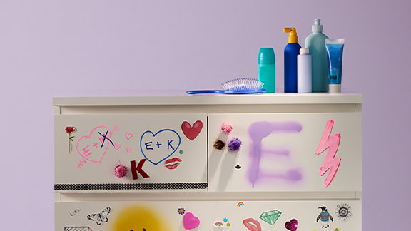 Dresser with colorful drawings all over.