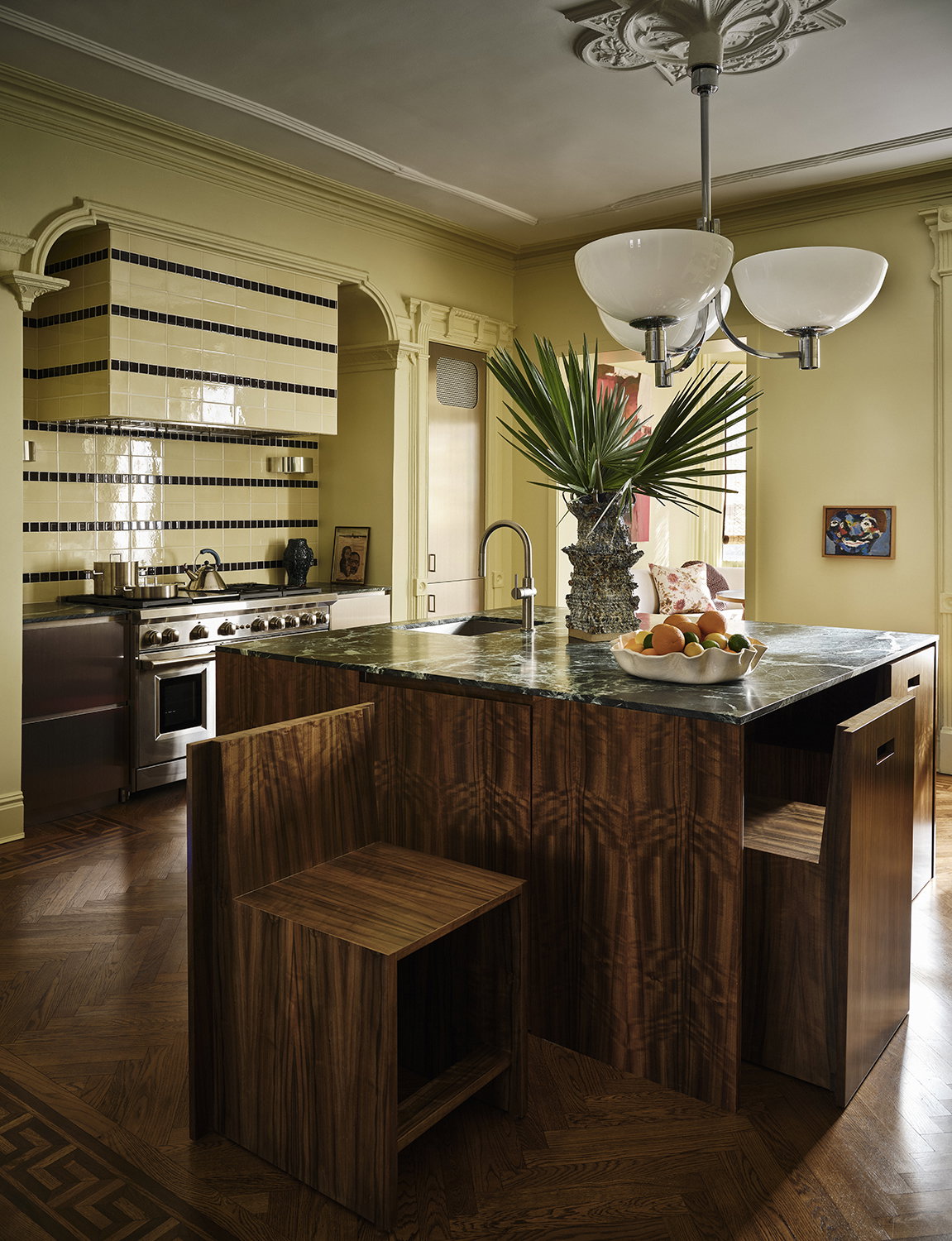 A moody kitchen with yellow walls.