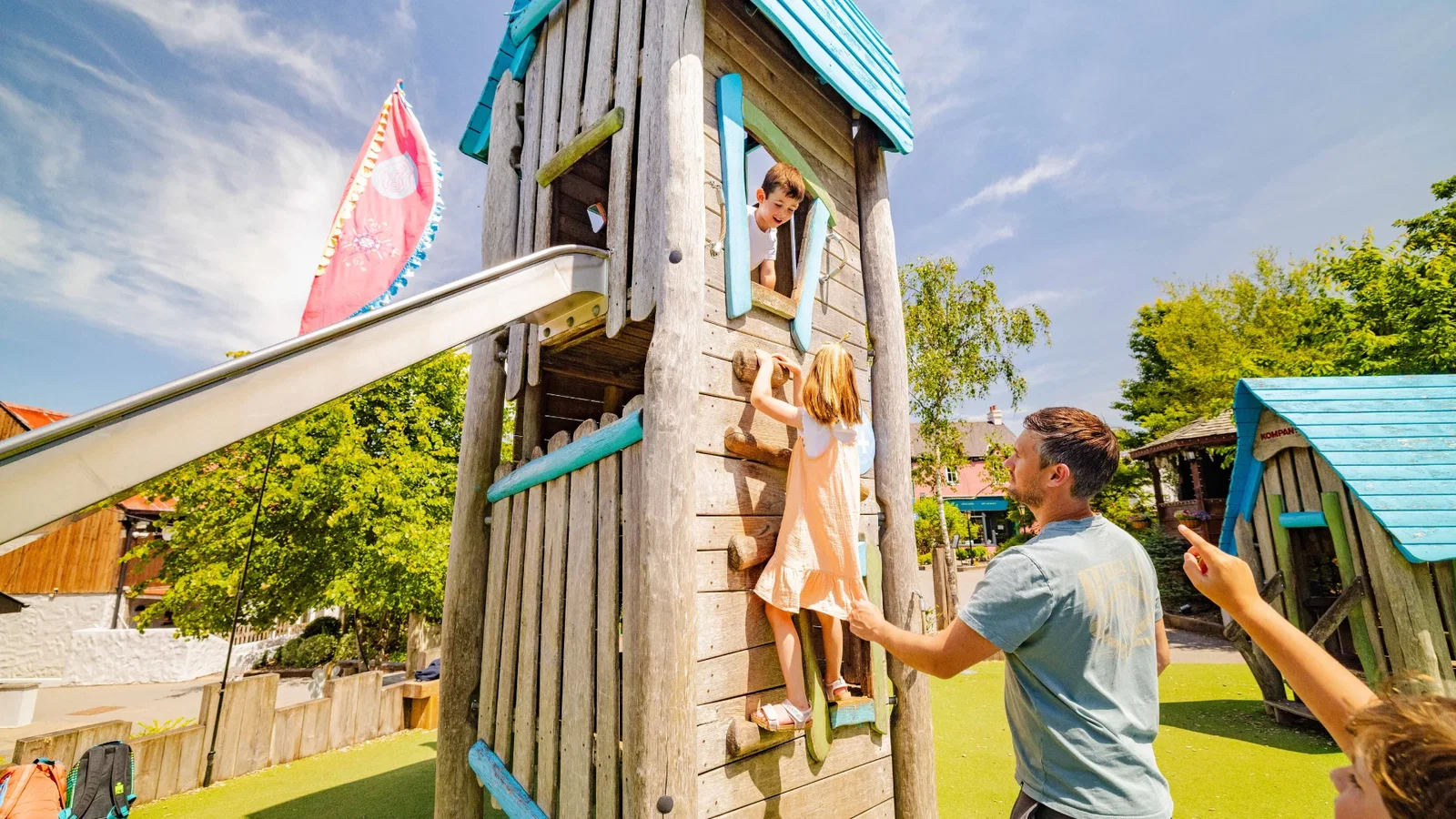 family at play park on sunny day