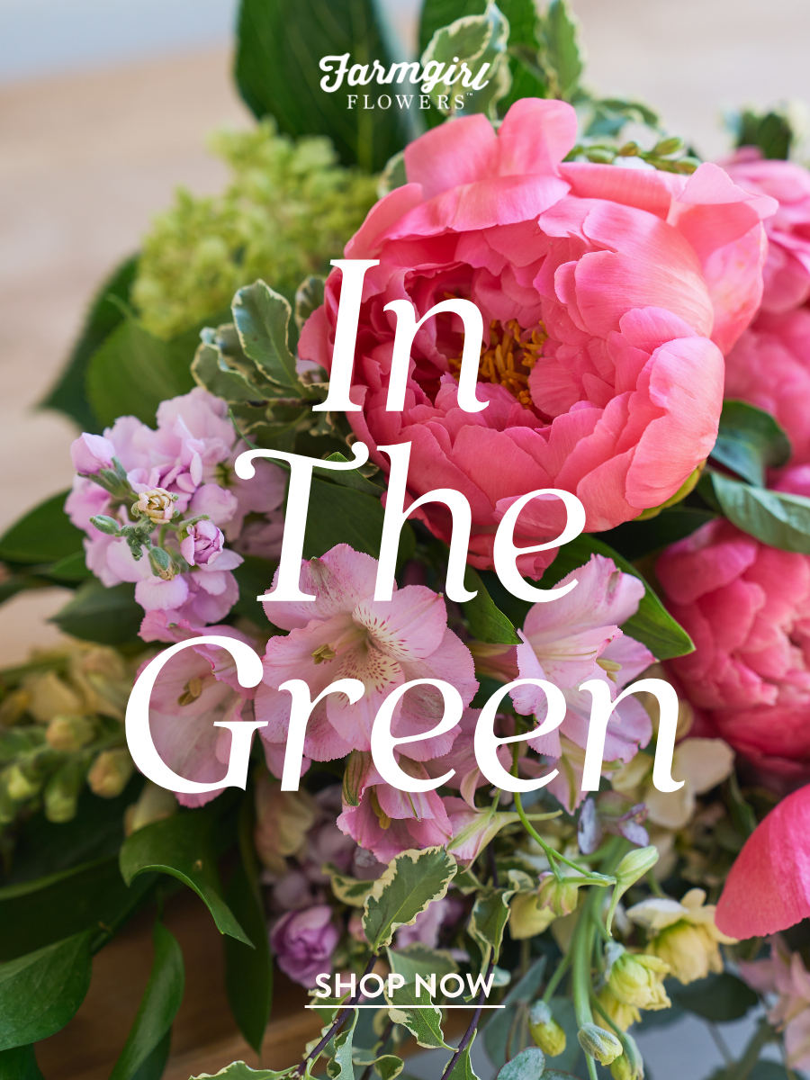 Close-up of a pink and green floral bouquet with large pink peonies, small pink flowers, green hydrangea, and greenery, with the Farmgirl Flowers logo and white text reading “In The Green.”