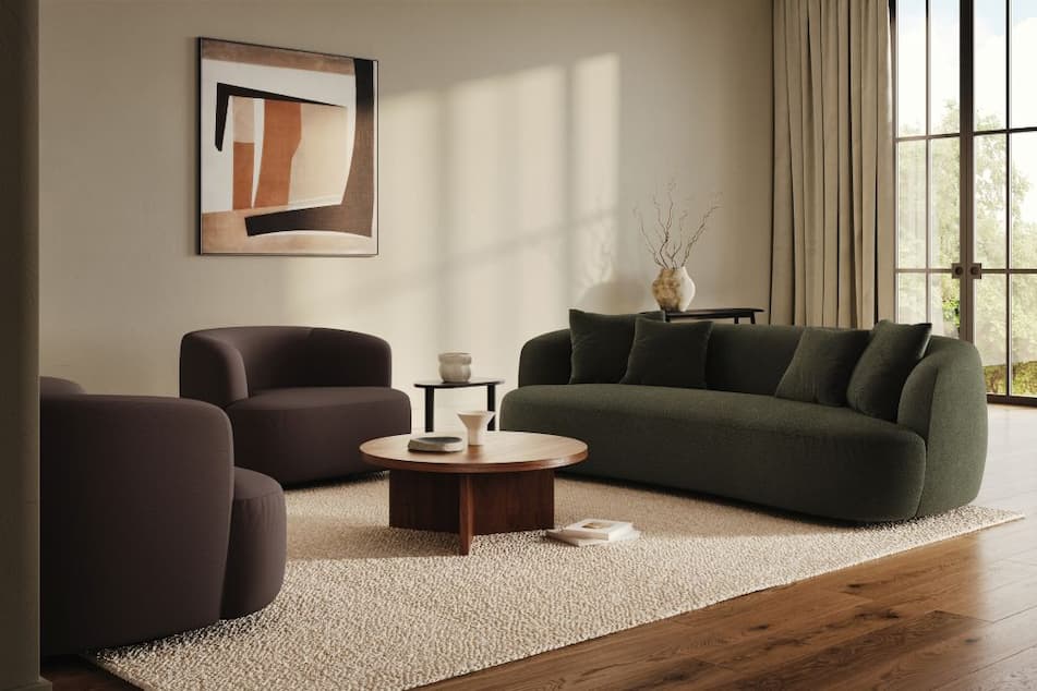 A sofa and two chairs are in a living room