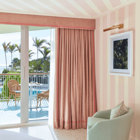 A room decorated in a pink and white striped motif. 