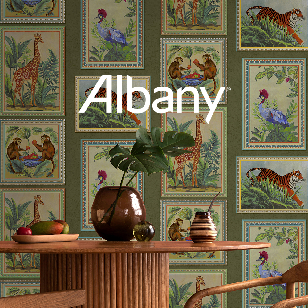 a living room with a couch and a wall mural of foliage