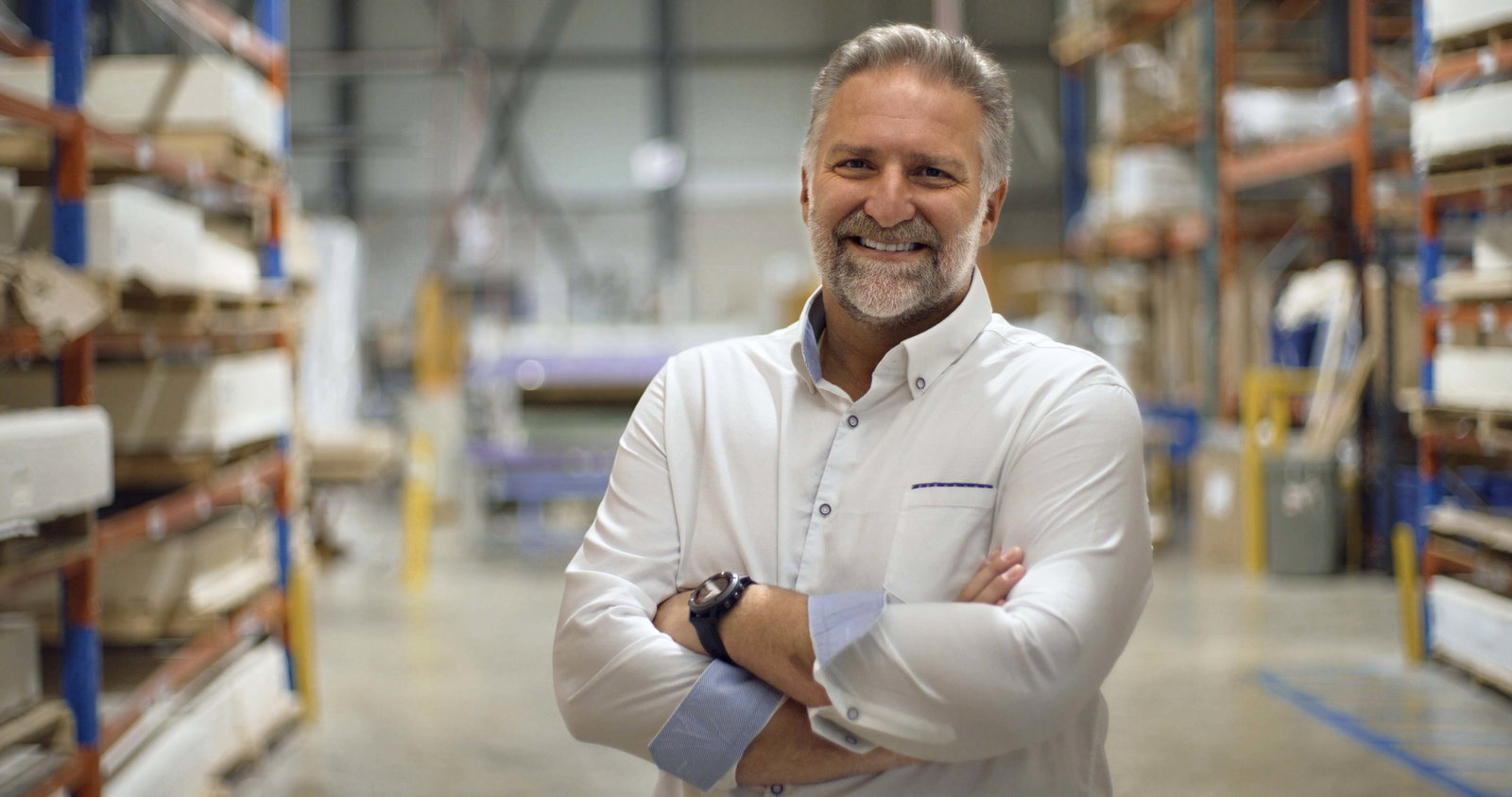 an image of Jack Dell'Accio standing in a warehouse with his arms crossed