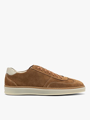 Brown suede trainers with white soles on a white background, side view.