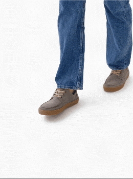 Sequence of a person walking in blue jeans and brown shoes on a white background.