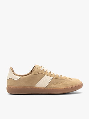 Side view of beige and white casual trainers with gum sole on white background.