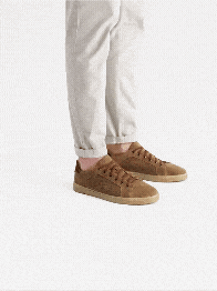 Man wearing beige trousers and brown trainers, multiple angles.