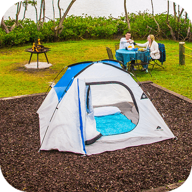 A white and blue tent at a campsite.