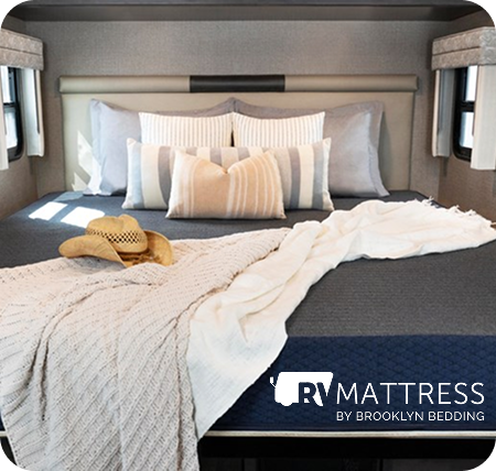 Bed in an RV with a logo that says RV Mattress by Brooklyn Bedding