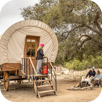 A large old-fashioned wagon made into lodging.