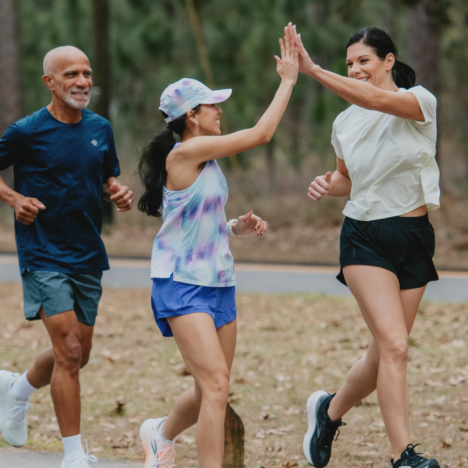 Group of runners high-fiving